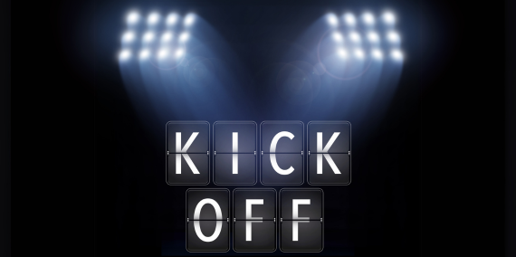 Scheinwerfer leuchten auf den Schriftzug "Kick-off" - Symbolbild.